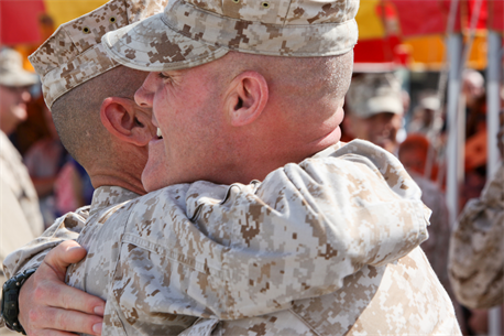 Sgt. Maj. Micheal P. Barrett, sergeant major of the Marine Corps, hugs Sgt. Maj. William F. Squires, former Marine Corps Air Station New River sergeant major, after his relief and appointment, and retirement ceremony aboard the air station, May 4. Squires passed the Sword of Office to the oncoming sergeant major, Sgt. Maj. Robert A. Allen. 